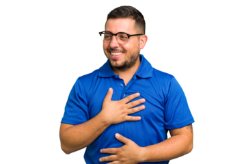 Young caucasian man isolated laughs happily and has fun keeping hands on stomach.