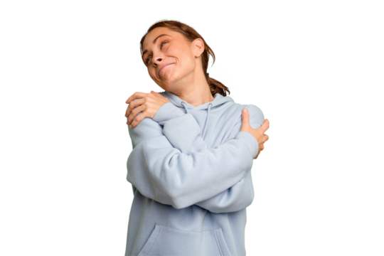 Young caucasian woman isolated hugs, smiling carefree and happy.