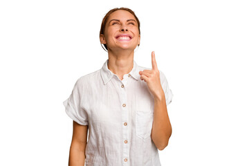 Young caucasian woman isolated indicates with both fore fingers up showing a blank space.
