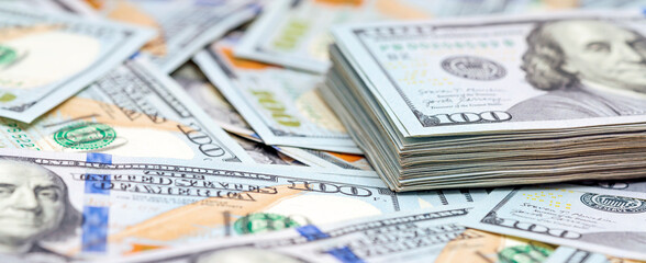 Heap of a dollar banknotes on a money background. Banner. Finance and economy concepts.