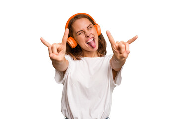 Young caucasian woman listening to music with headphones isolated
