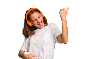 Young caucasian woman listening to music with headphones isolated