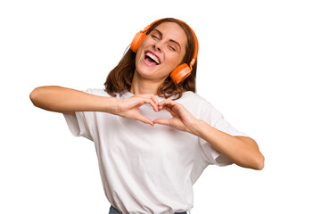 Young caucasian woman listening to music with headphones isolated