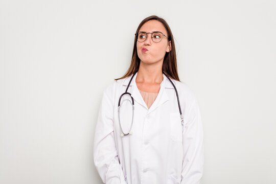 Young Doctor Woman Isolated On White Background Confused, Feels Doubtful And Unsure.