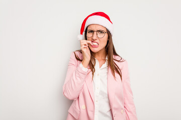 Business caucasian woman wearing a christmas hat isolated on white background biting fingernails, nervous and very anxious.