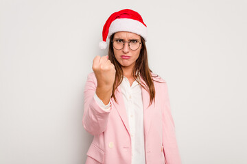 Business caucasian woman wearing a christmas hat isolated on white background showing fist to camera, aggressive facial expression.