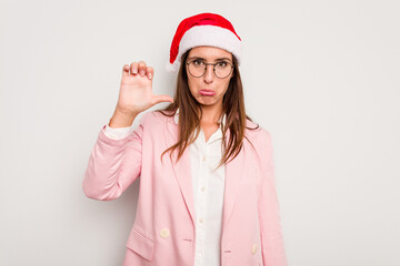 Business caucasian woman wearing a christmas hat isolated on white background showing a dislike gesture, thumbs down. Disagreement concept.