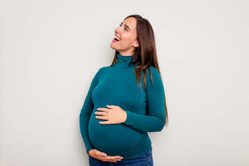 Pregnant caucasian woman isolated on white background shouting and holding palm near opened mouth.