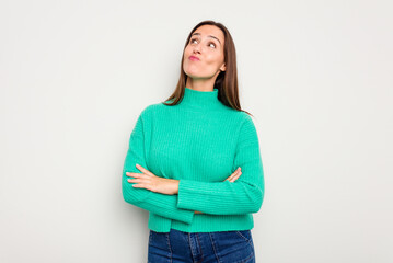 Young caucasian cute woman isolated on white background dreaming of achieving goals and purposes