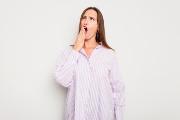 Young caucasian cute woman isolated on white background yawning showing a tired gesture covering mouth with hand.