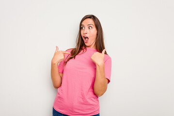 Fototapeta premium Young caucasian cute woman isolated on white background surprised pointing with finger, smiling broadly.