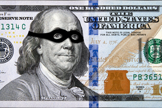 Portrait Of Benjamin Franklin In A Black Mask Of A Robber On A Banknote Of One Hundred Dollars. Predatory Bank Interest On A Mortgage Loan.