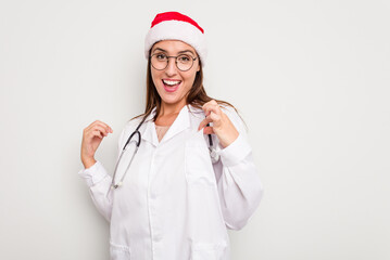 Young caucasian doctor woman wearing a santa hat isolated on white background