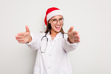 Young caucasian doctor woman wearing a santa hat isolated on white background