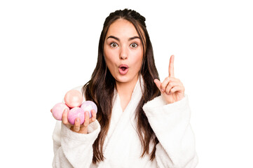 Young caucasian woman holding aromatic balls for bathtub isolated on green chroma background having...