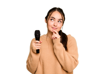 Young caucasian singer woman isolated on green chroma background looking sideways with doubtful and skeptical expression.