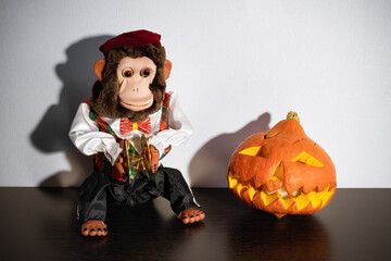 Retro toy monkey with cymbals jolly chimp and jack-o'-lantern 