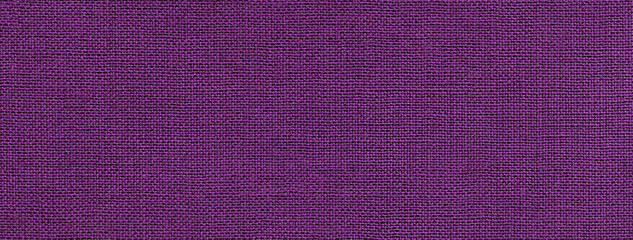 Texture of dark violet color background from textile material with wicker pattern. Vintage lavender fabric