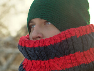 A teenager dressed warmly in winter. Schoolboy in winter with scarf and hat. Soft focus on the face