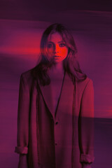 High Fashion model girl in bright neon UV lights posing in studio, portrait of a beautiful woman,...
