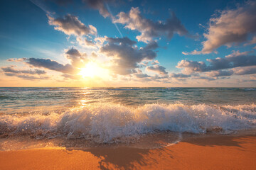 Fototapeta na wymiar Beach sunrise over the tropical sea waves and island sand