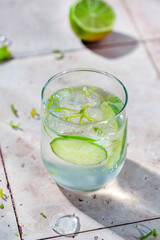 Tasty refreshing drink with lime, ice and sparkling water