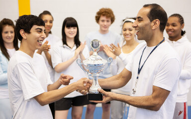 Sports Students: First Prize. A trophy presentation for a teenage sportsman with encouragement from...