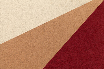 Texture of old craft beige, brown and wine color paper background, macro. Vintage abstract red cardboard