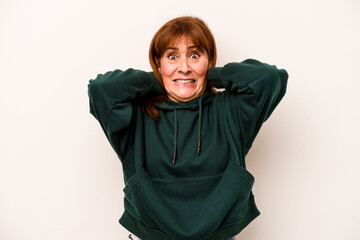 Middle age caucasian woman isolated on white background screaming with rage.