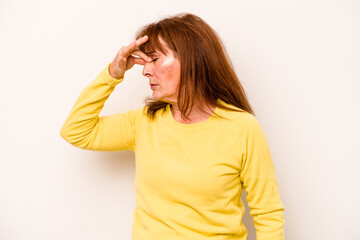 Middle age caucasian woman isolated on white background having a head ache, touching front of the face.