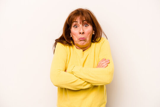 Middle age caucasian woman isolated on white background shrugs shoulders and open eyes confused.