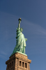 Fototapeta premium Magnificent view from the ground from below to the Statue of Liberty on a pedestal