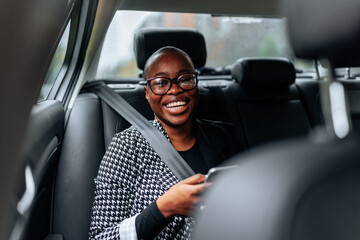 Cheerful African American woman in car.