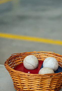 detail of some fronton balls inside a wicker basket. basque pelota. vertical format. concept sports in basque country. spain.