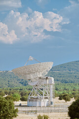 Radio Telescope for astrophysical investigation in forest with blue sky