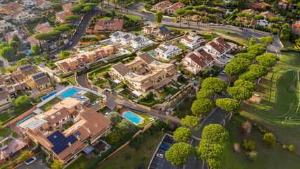 Aerial view of a prestigious residential area at sunset. Almost all the houses are villas with a...