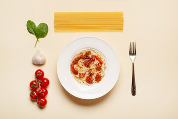 top view of pasta with meat near tomato, garlic, basil leaves and fork on beige background