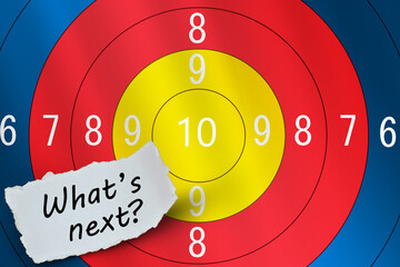 What is next word on paper with target board as background