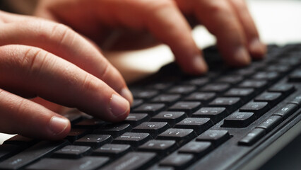Man hands typing on computer keyboard. Working on laptop, send emails, make web seach, programmer job. Technology concept