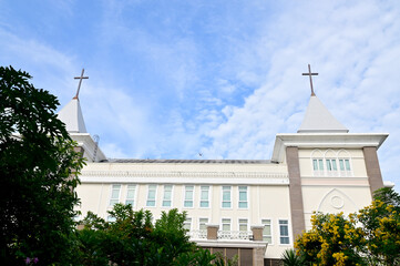 Church Roof with a cross. Church building roof with holy cross. Cloudy moody sky background. 