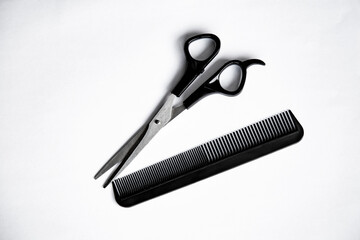 comb and scissors on white background 
