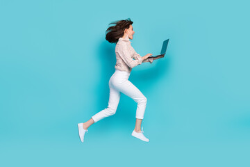 Fototapeta na wymiar Side profile photo of excited crazy woman jumping air trampoline hurry done her homework education deadline hold laptop isolated on blue color background