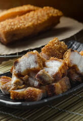 crispy pork belly deep fried pork or Chinese roasted pork belly on a wooden chopping board. close-up shot