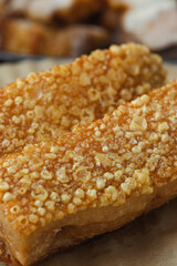crispy pork belly deep fried pork or Chinese roasted pork belly on a wooden chopping board. close-up shot