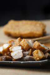 crispy pork belly deep fried pork or Chinese roasted pork belly on a wooden chopping board. close-up shot