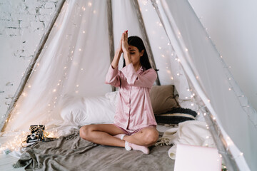 Asian woman meditating in yoga pose in wigwam tent © BullRun