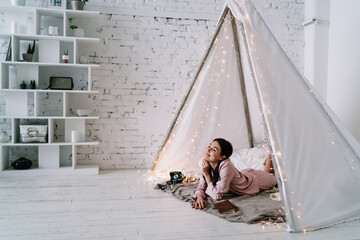 Asian woman lying and resting in wigwam tent © BullRun