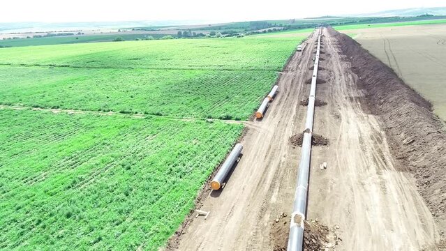 Aerial view of gas and oil pipeline construction. Pipes welded together. Big pipeline is under construction.