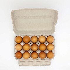 Topview of cardboard egg box with fifteen brown eggs isolated on white background.
