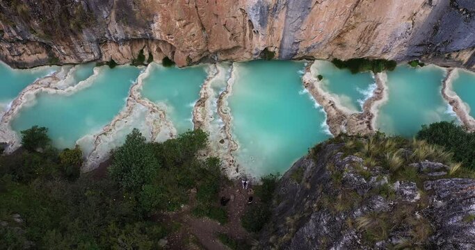 Beautiful overhead aerial shot with a drone from the Andes area of the famous turquoise Lake Millpu located between mountains in the afternoon located in Ayacucho, Peru.